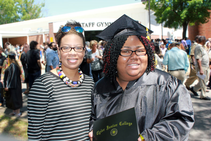 Scholarship student right during graduation ceremony, standing with Educational Services Manager, Lori Arteaga