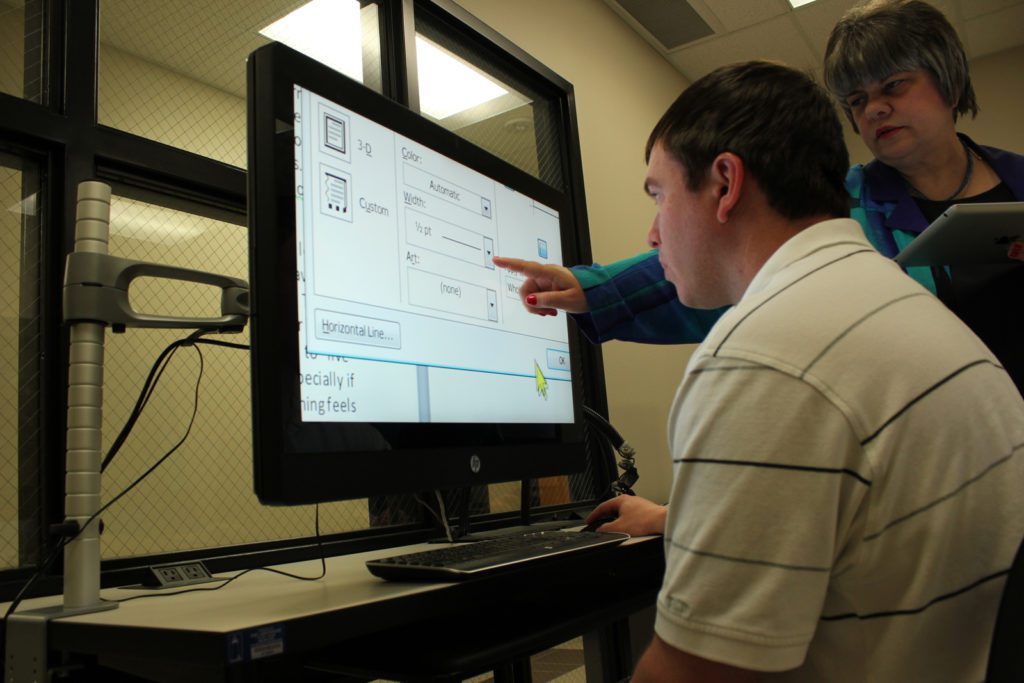 client in Microsoft Office classroom with enlarged print on the computer screen