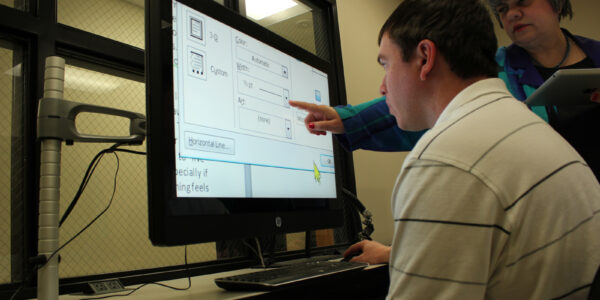 client in Microsoft Office classroom with enlarged print on the computer screen